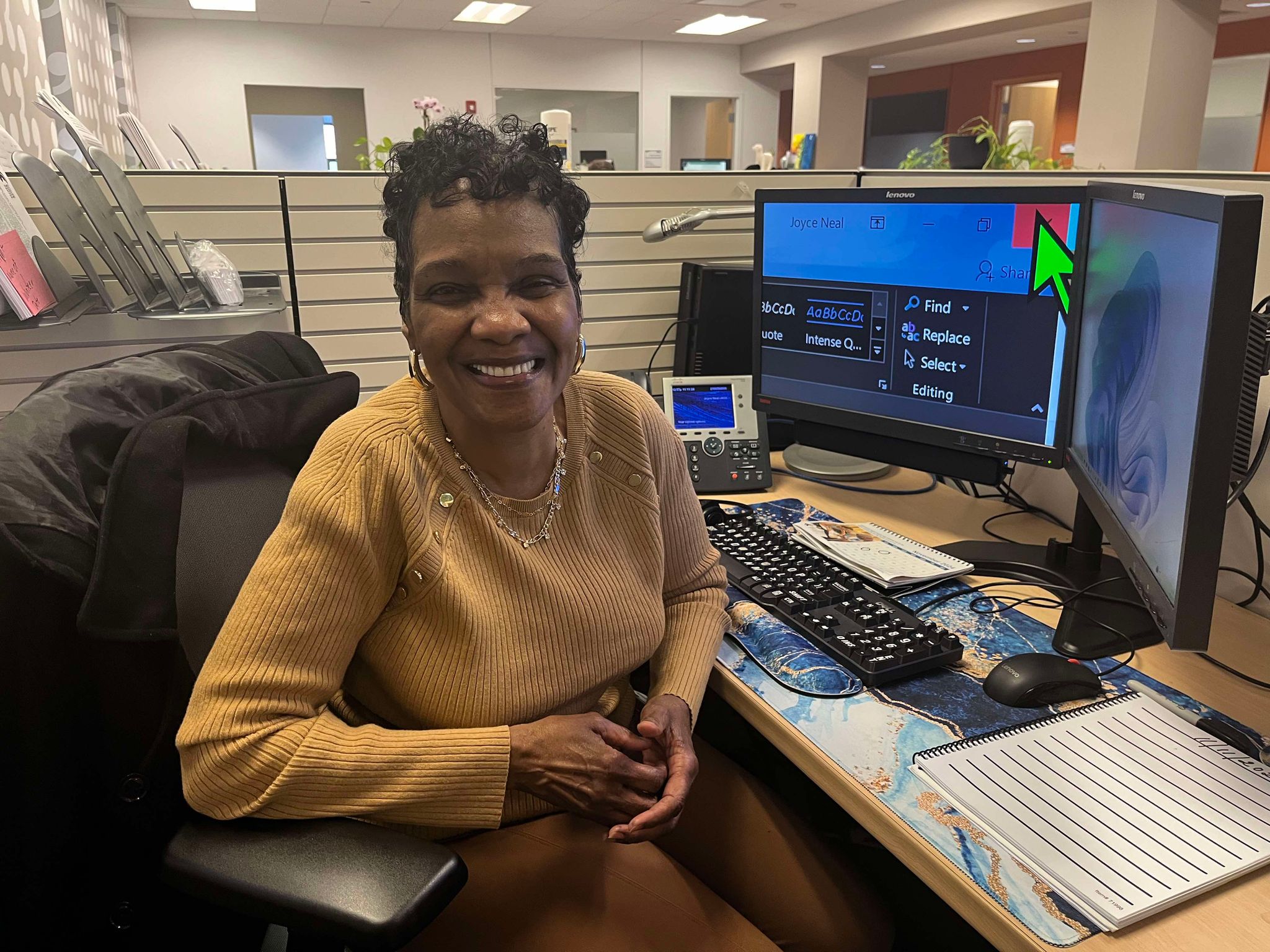 Joyce smiles at her desk at Cleveland Sight Center