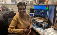 Joyce smiles at her desk at Cleveland Sight Center