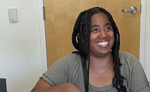 A woman smiles in CSC's prep kitchen