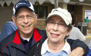 A photo of Mike and Fran Weissman smiling while wearing Cleveland Sight Center baseball caps